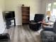 Living room featuring neutral paint, grey flooring, and a large window at 8124 Wood St, Mount Pleasant, NC 28124