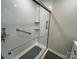 Modern shower featuring white walls, and chrome grab bars at 8124 Wood St, Mount Pleasant, NC 28124