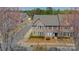 Aerial view of a brick townhome showcasing its location in a neighborhood with mature trees and landscaping at 9001 Lanark Ln, Indian Land, SC 29707