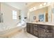 Bright bathroom features a soaking tub, double vanity, and a separate water closet at 9001 Lanark Ln, Indian Land, SC 29707
