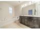 Bright bathroom featuring a soaking tub, dual vanity, and ample counter space for all your needs at 9001 Lanark Ln, Indian Land, SC 29707