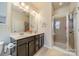 Nicely appointed bathroom with double sinks, large mirror, and glass-enclosed shower at 9001 Lanark Ln, Indian Land, SC 29707