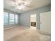 Spacious bedroom with ceiling fan, natural light and ensuite bathroom for added privacy at 9001 Lanark Ln, Indian Land, SC 29707