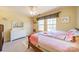 Sunny bedroom with a colorful theme, featuring a ceiling fan, a dresser, and windows that allow lots of natural light at 9001 Lanark Ln, Indian Land, SC 29707