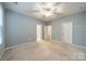 Large bedroom featuring a ceiling fan, plush carpet, and ensuite bathroom for added convenience at 9001 Lanark Ln, Indian Land, SC 29707