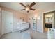 Bright Bedroom with a crib, ceiling fan, and charming decor, creating a cozy space for your little one at 9001 Lanark Ln, Indian Land, SC 29707