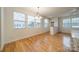 Dining area featuring hardwood floors, natural light, and a modern chandelier at 9001 Lanark Ln, Indian Land, SC 29707