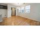 Dining area with hardwood floors, abundant natural light, and modern light fixture at 9001 Lanark Ln, Indian Land, SC 29707
