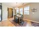 Bright dining area with hardwood floors, a chandelier, and large windows offering natural light at 9001 Lanark Ln, Indian Land, SC 29707