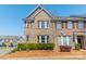 Charming brick townhome with well-maintained landscaping and a welcoming facade under a clear blue sky at 9001 Lanark Ln, Indian Land, SC 29707