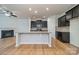 Kitchen with granite counters, dark cabinets, and a view into the adjacent living room with fireplace at 9001 Lanark Ln, Indian Land, SC 29707