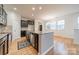Bright kitchen features dark cabinetry, granite countertops, stainless steel appliances, and a spacious kitchen island at 9001 Lanark Ln, Indian Land, SC 29707