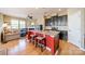 Stylish kitchen island with granite countertops, bar seating, and views of the living room and fireplace at 9001 Lanark Ln, Indian Land, SC 29707