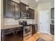 Well-equipped kitchen featuring stainless steel appliances, dark cabinetry, and granite countertops at 9001 Lanark Ln, Indian Land, SC 29707