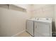 This laundry room contains a washer, dryer, and storage at 9001 Lanark Ln, Indian Land, SC 29707