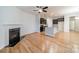 Open floor plan features a bright living room with fireplace adjacent to a kitchen with dark cabinets and granite countertops at 9001 Lanark Ln, Indian Land, SC 29707