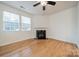 Bright living room with a fireplace, large windows, and wood flooring perfect for entertaining and relaxation at 9001 Lanark Ln, Indian Land, SC 29707