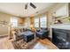 Cozy living room features a fireplace, hardwood floors, and comfortable seating at 9001 Lanark Ln, Indian Land, SC 29707