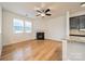 Cozy living room with fireplace, ceiling fan, and natural light, adjacent to kitchen, perfect for gatherings at 9001 Lanark Ln, Indian Land, SC 29707