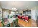 Open-concept living space with a dining area, kitchen island, and cozy living room featuring a fireplace at 9001 Lanark Ln, Indian Land, SC 29707