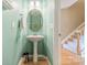 Charming powder room featuring a pedestal sink, decorative mirror, and stylish wall color at 9001 Lanark Ln, Indian Land, SC 29707