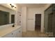 Contemporary bathroom features glass enclosed shower and a large vanity with mirror at 919 Mankey Dr, Huntersville, NC 28078