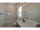 Bright bathroom features tub-shower combination and modern vanity with white countertop at 919 Mankey Dr, Huntersville, NC 28078