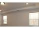 Brightly lit bedroom showcases trim and two windows allowing natural light at 919 Mankey Dr, Huntersville, NC 28078