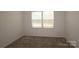 Comfortable bedroom with plush carpet and a large window, creating a peaceful retreat for rest and relaxation at 919 Mankey Dr, Huntersville, NC 28078