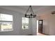 Inviting dining room with elegant chandelier, wainscoting, natural light, and view to door at 919 Mankey Dr, Huntersville, NC 28078