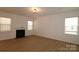 Bright living room boasts a cozy fireplace, large windows, and hardwood floors, providing a warm and inviting space at 919 Mankey Dr, Huntersville, NC 28078