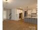 Spacious open-concept living area with hardwood floors seamlessly connects the kitchen and dining areas at 919 Mankey Dr, Huntersville, NC 28078