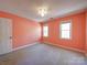 This bedroom features neutral carpeting, peach-painted walls, and two double-hung windows at 940 Brittany Ct # 23, Gastonia, NC 28056