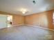 Spacious bedroom with neutral carpet, a ceiling fan, and an ensuite bathroom at 940 Brittany Ct # 23, Gastonia, NC 28056