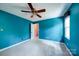 This bedroom features a ceiling fan and a spacious closet, complemented by natural light from the window at 940 Brittany Ct # 23, Gastonia, NC 28056