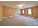 Spacious bedroom with neutral carpet and two windows at 940 Brittany Ct # 23, Gastonia, NC 28056