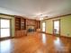 Open living room featuring a brick fireplace, custom built-ins, and hardwood floors at 940 Brittany Ct # 23, Gastonia, NC 28056
