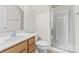 Bathroom with a wood vanity, framed mirror, toilet and glass shower at 9506 Minnie Lemmond Ln # 170, Mint Hill, NC 28227