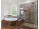 Luxurious bathroom featuring a soaking tub and tiled walk-in shower at 9506 Minnie Lemmond Ln # 170, Mint Hill, NC 28227