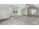 A spacious bedroom has neutral carpet, angled ceilings, windows providing natural light, and a ceiling fan at 9506 Minnie Lemmond Ln # 170, Mint Hill, NC 28227