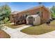Backyard showcases a shed, brick home, and wood deck with stairs, complemented by green grass and walkways at 9506 Minnie Lemmond Ln # 170, Mint Hill, NC 28227