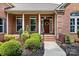 Inviting front porch featuring a brick facade, decorative columns, and a stylish front door at 9506 Minnie Lemmond Ln # 170, Mint Hill, NC 28227