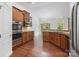 Kitchen with stainless steel appliances, a breakfast bar, and hardwood floors at 9506 Minnie Lemmond Ln # 170, Mint Hill, NC 28227