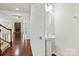 Hallway features a pedestal sink and access to the living room with a fireplace at 9506 Minnie Lemmond Ln # 170, Mint Hill, NC 28227