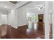 Open-concept living area with hardwood floors and a stone fireplace, with access to the kitchen at 9506 Minnie Lemmond Ln # 170, Mint Hill, NC 28227