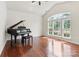 Elegant living room with vaulted ceiling, large windows, and a grand piano at 9506 Minnie Lemmond Ln # 170, Mint Hill, NC 28227