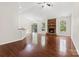 Inviting living room with a stone fireplace, hardwood floors, and natural light at 9506 Minnie Lemmond Ln # 170, Mint Hill, NC 28227