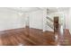 Spacious living room with hardwood floors, elegant trim, and access to the staircase at 9506 Minnie Lemmond Ln # 170, Mint Hill, NC 28227