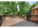 Spacious wooden deck with dark brown railings and stairs offers an inviting outdoor space with privacy and views at 9506 Minnie Lemmond Ln # 170, Mint Hill, NC 28227