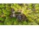A home in the woods with driveway, parking area, and turnaround at 9820 Janeiro Dr, Huntersville, NC 28078